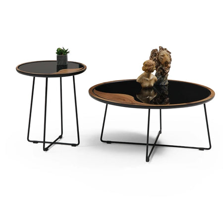 Two round coffee tables with black tops and metal legs on a white background