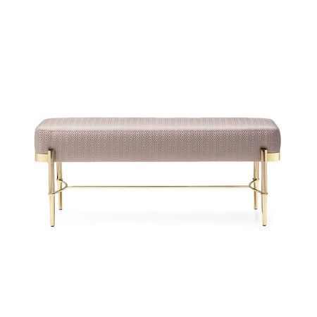 Beige upholstered bench with gold metal legs on a white background