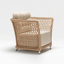 Wide garden armchair in resin wicker rattan style with plush Olefin cushion on white background – part of Begonia Collection by Trendgoat
