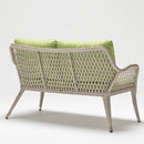 Trendgoat Iris 2-seater outdoor sofa featuring compact form, handwoven rattan detail, and UV-resistant Olefin cushions