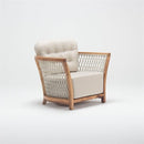 Spacious wooden garden armchair with handwoven rattan detailing and deep foam-filled chesterfield cushion, part of Lavender Lounging Collection by Trendgoat