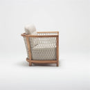 Spacious wooden garden armchair with handwoven rattan detailing and deep foam-filled chesterfield cushion, part of Lavender Lounging Collection by Trendgoat side view