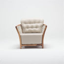 Spacious wooden garden armchair with handwoven rattan detailing and deep foam-filled chesterfield cushion, part of Lavender Lounging Collection by Trendgoat front view