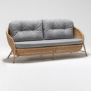 Large three-seater light brown rattan garden sofa with gray plush Olefin cushions by Trendgoat. part of Oleander Plus Collection side angle